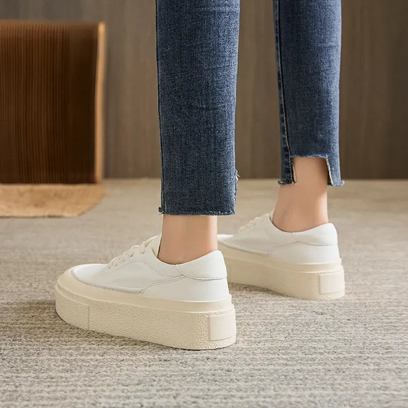 Women's black platform casual board shoes with embossed cowhide upper and round toe design