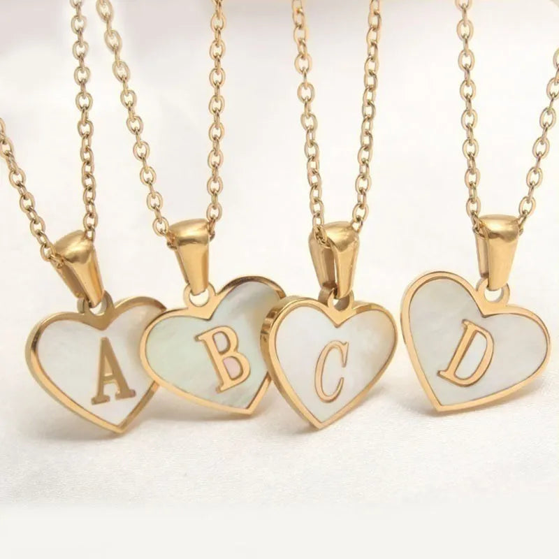 Gold plated heart-shaped necklace with white shell pendant on adjustable stainless steel chain