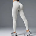 Women's mid-waist yoga pants in cotton blend fabric with hip-lifting design for fitness activities