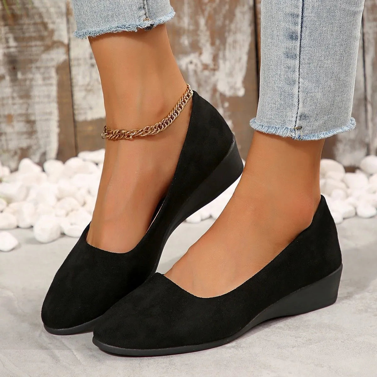 Women's suede wedge pumps in light brown colour showing shallow mouth design and low wedge heel