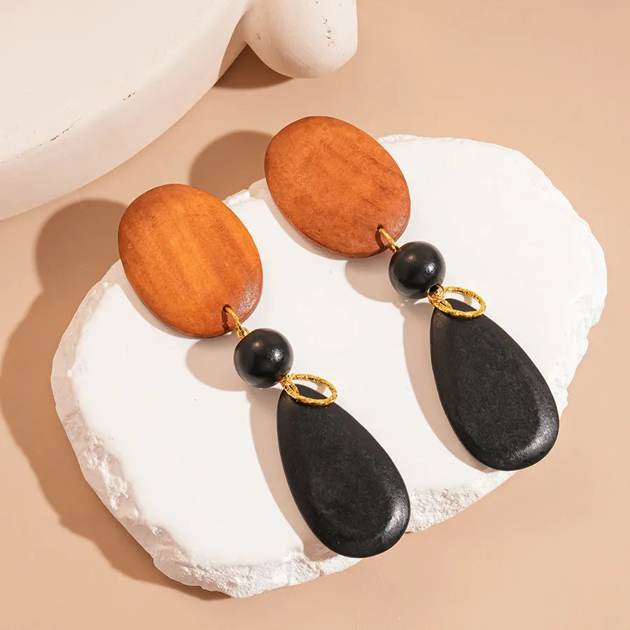 Handcrafted wooden ellipse earrings in silver brown black colours with retro European American style