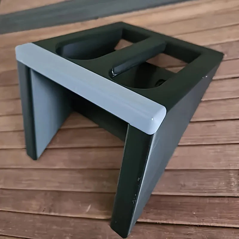 Black punk-style plastic pistol display stand measuring 10.85cm by 7.6cm