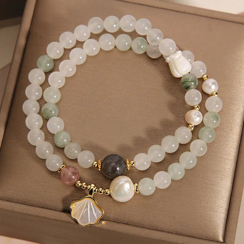Women's crystal bracelet with an apricot leaf and jade shell pendant, gold-plated settings, and rhinestones.