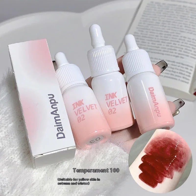 Mirror Lip Lacquer lip gloss tube in one of four shades: Spring Day Wilderness, Orange Tabby Cat Diary, Low-key Charming, or Misty Berry.