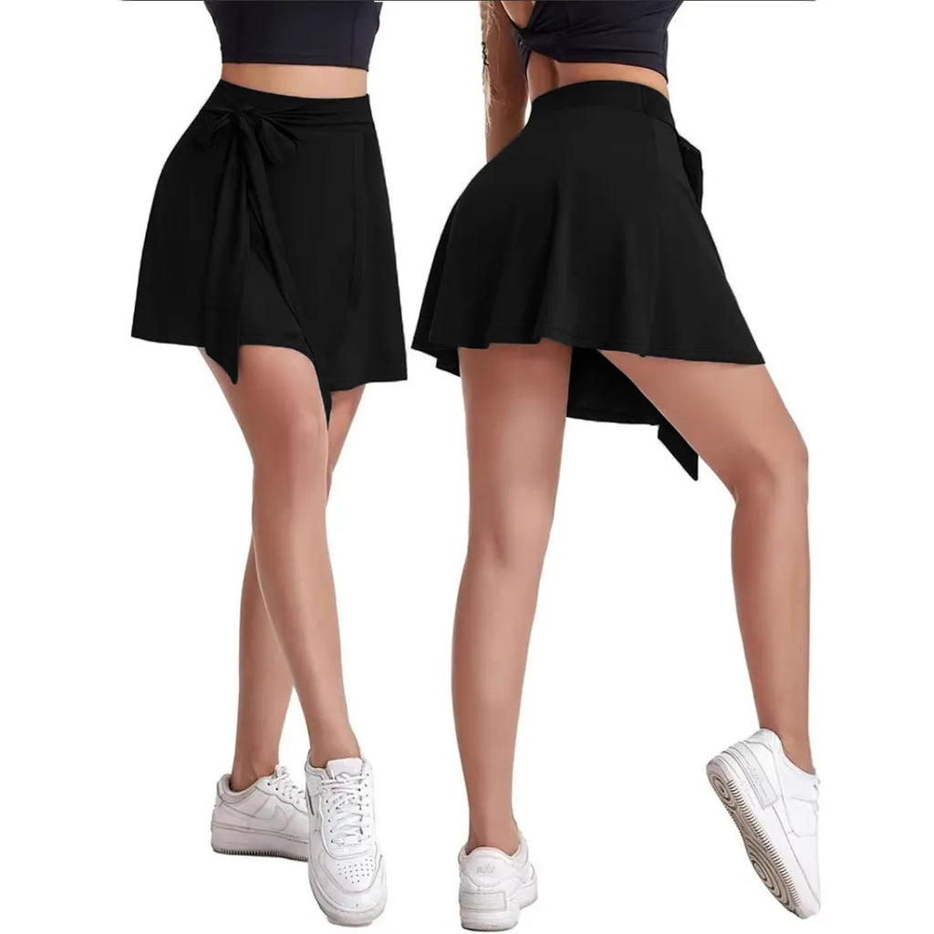 Black thigh-length sports skirt with built-in shorts, high waist, and culotte style.