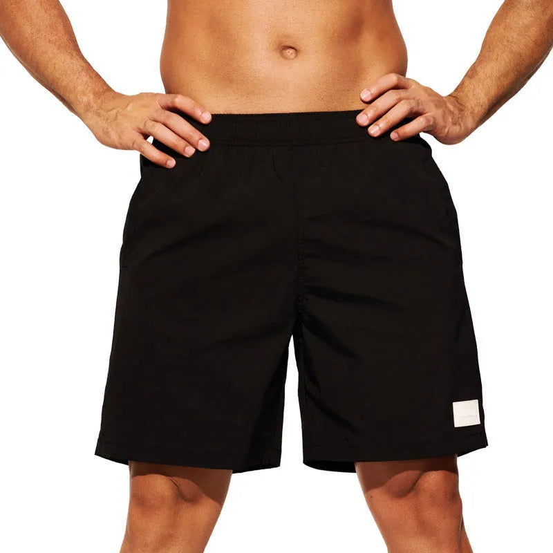 Men's quick-drying nylon beach shorts in solid colours with straight leg opening