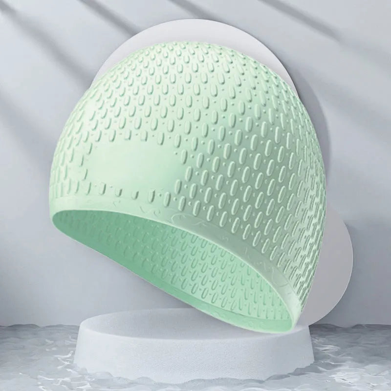 Silicone water drop design swimming cap for adults shown in various colours.