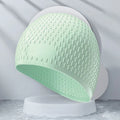 Silicone water drop design swimming cap for adults shown in various colours.