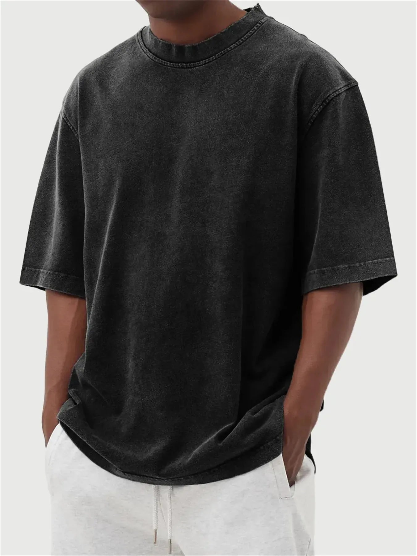 Men's loose fit pullover T-shirt in a stone-washed distressed solid colour, shown in army green.