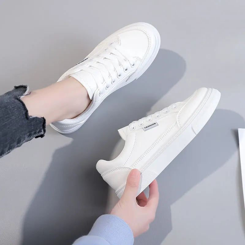 Women's low-top Korean style sneaker in white or brown artificial PU leather with a plastic sole.