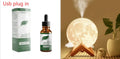 Lunar sphere humidifier and night light in wood finish with white LED light on a bedside table