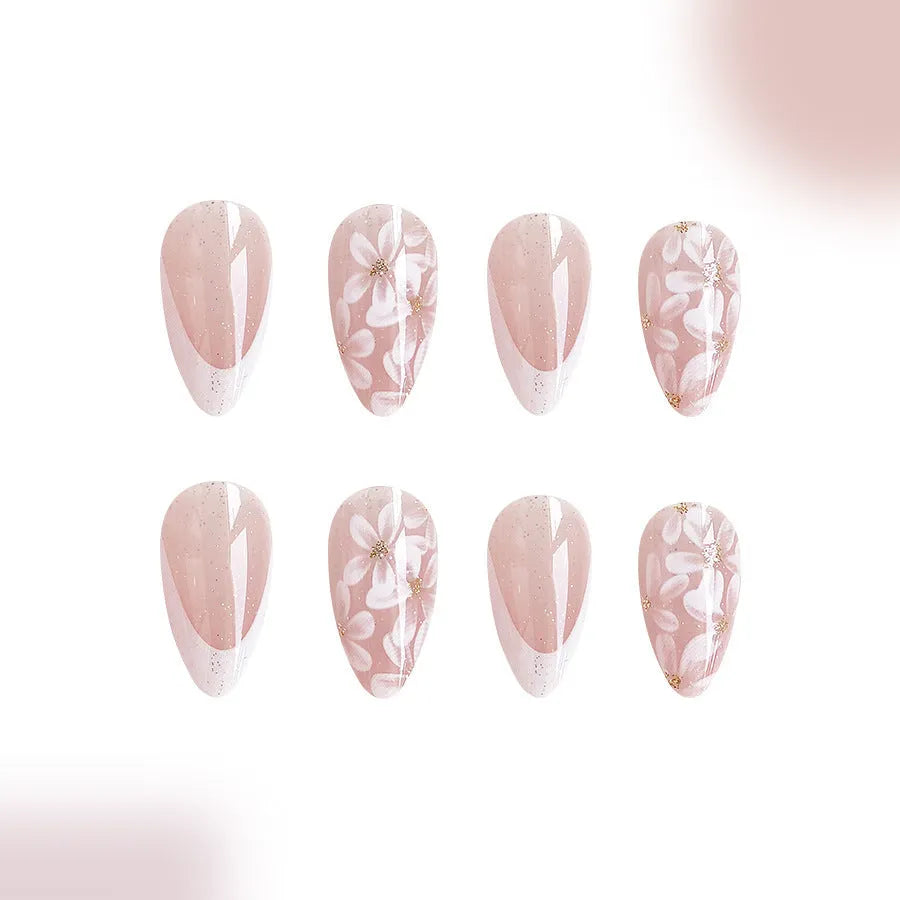 Short almond artificial nails with French style glitter flower decoration in C625 colour