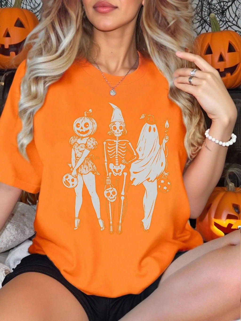 Loose fit cotton short sleeve T-shirt in black, green, grey, or orange on a hanger