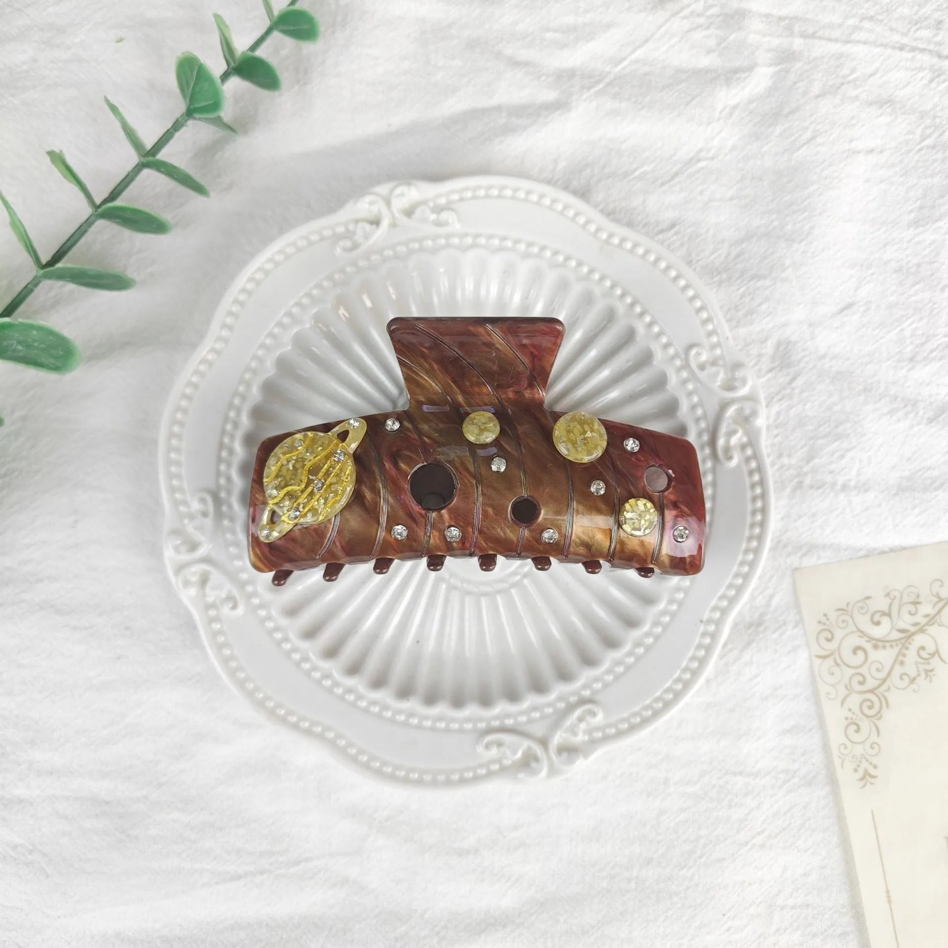 Oversized women's barrette with a starry sky design in blue, made from cellulose acetate sheet.