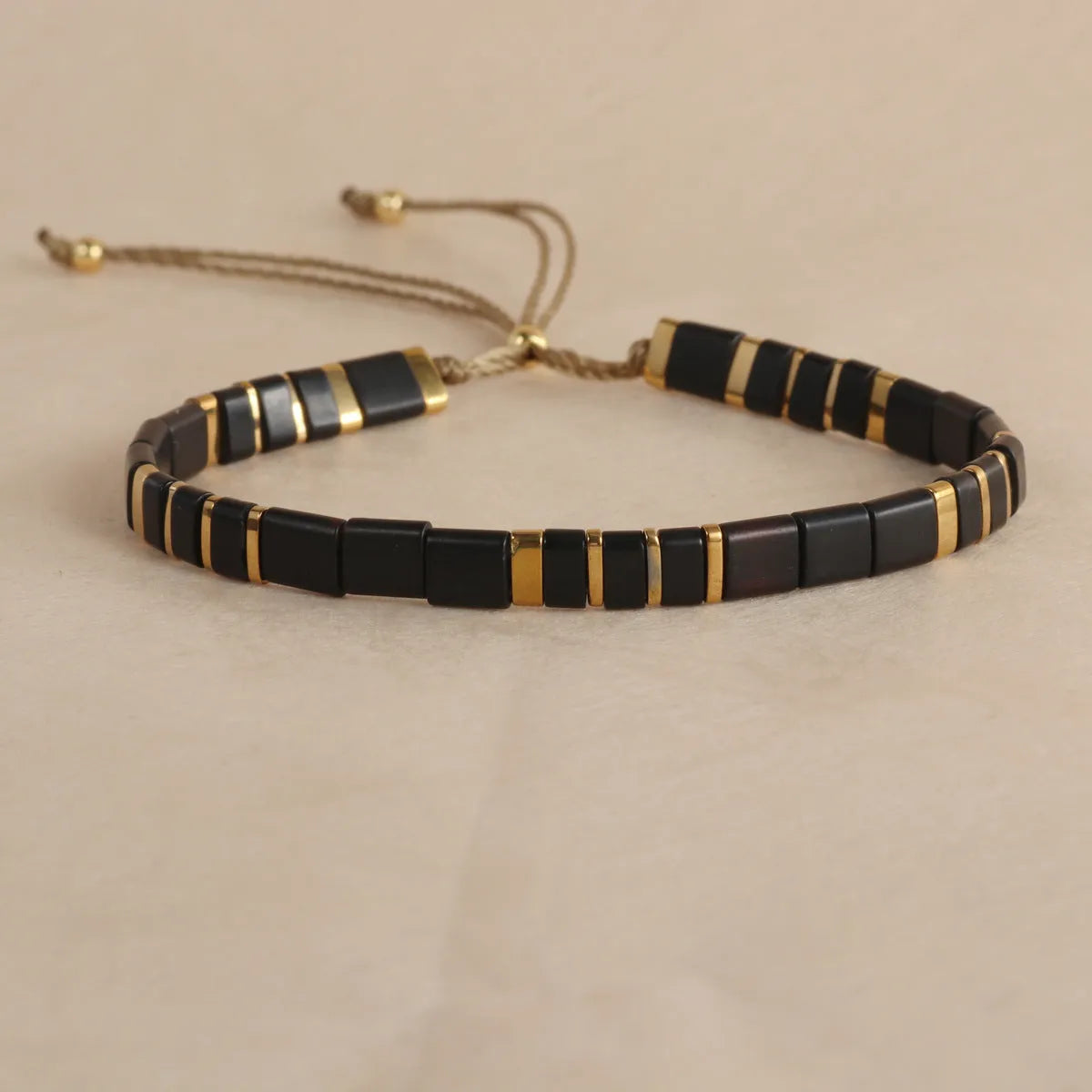 Geometric pull bead bracelet with round glass beads in multiple colour options.