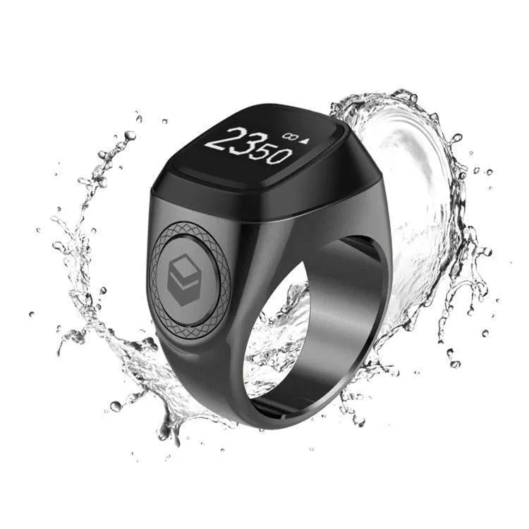 Zikr1 Lite Tasbih smart ring in silver on a charging case with USB cable.