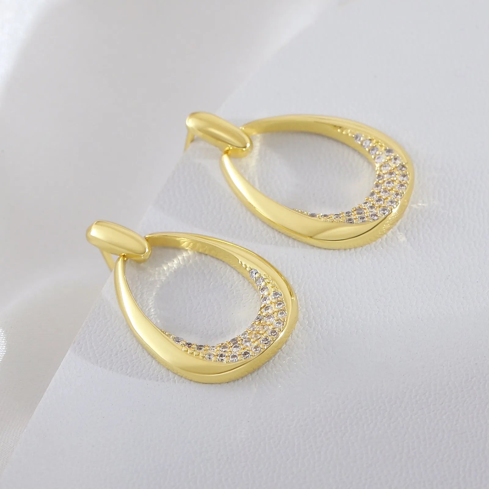 Yellow gold geometric drop earrings with round and oval elements measuring 2.6cm by 1.7cm