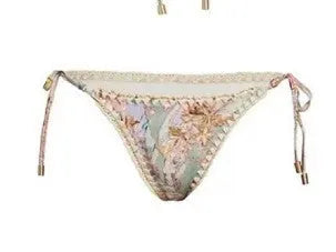 Women's creamy white floral bikini set with skirt cover-up on beach