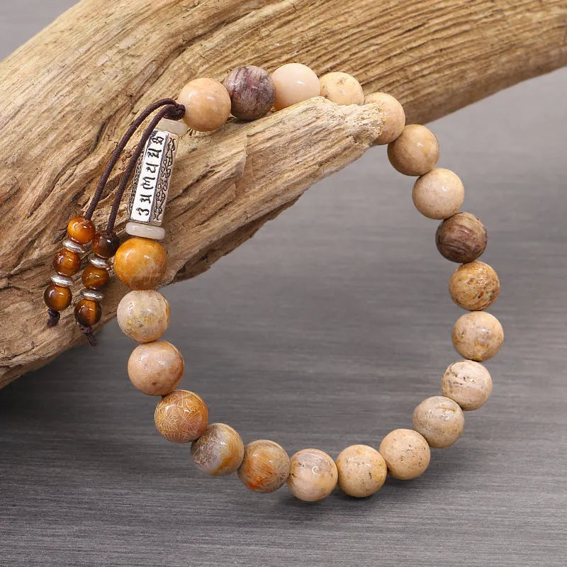 Handmade wood colour stone bead bracelet with retro design on a wrist