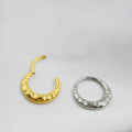 Titanium alloy concave-convex nose ring in gold and silver finishes showing surface texture detail