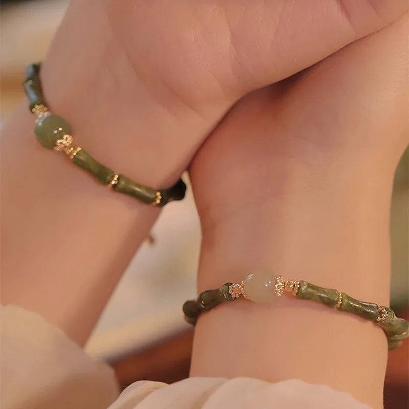 A geometric beaded bracelet made from dark green Hetian jade for women, showing a simple round style.