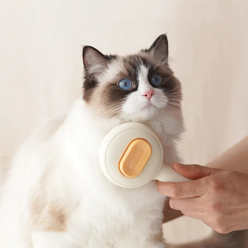Green and yellow non-slip handle cat grooming brush with stainless steel comb teeth.
