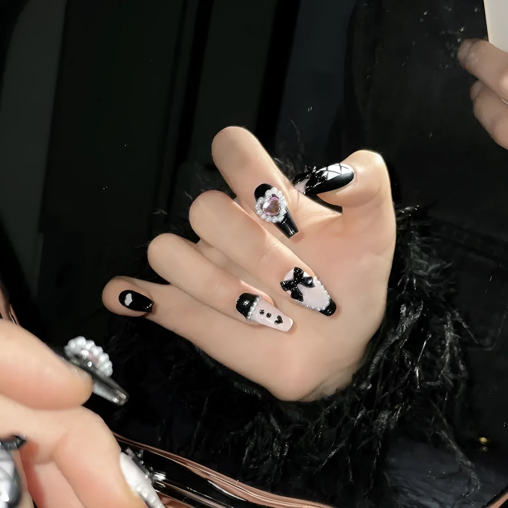 Black peach heart hand-painted detachable manicure set showing cat's eye design with bow patterns