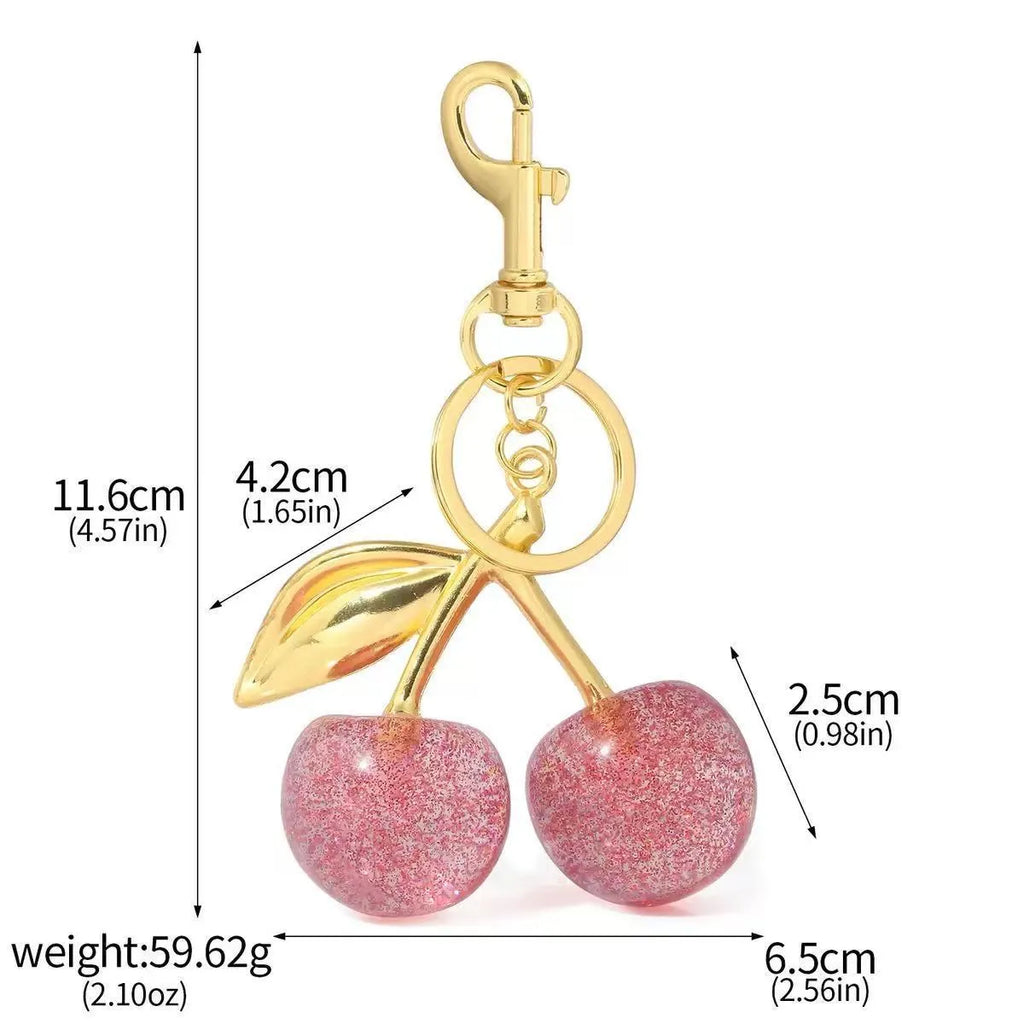 Red zinc alloy three-dimensional cherry pendant charm for key rings and bags.