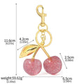 Red zinc alloy three-dimensional cherry pendant charm for key rings and bags.