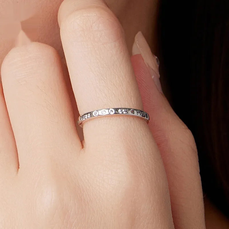 Oxidised black silver 'I Love You' moss password fashion ring on a hand, showing its bracelet-style design.