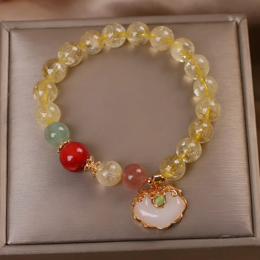 Women's bracelet with a yellow hair crystal jade ruyi pendant on an alloy chain.