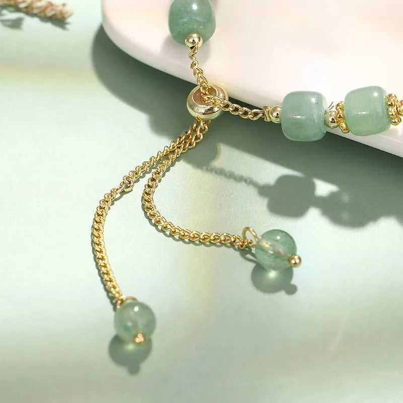 Rabbit charm bracelet with green aventurine or strawberry quartz beads on a gold-coloured adjustable chain.