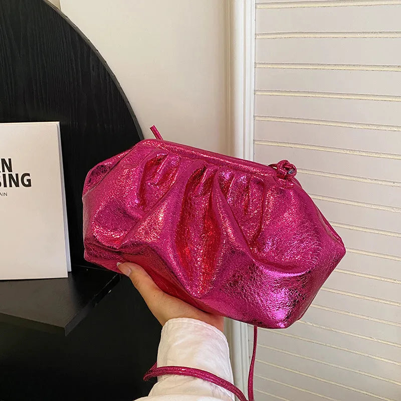 Shell-shaped crossbody bag with hair clip shoulder strap showing multiple compartments including mobile phone pocket