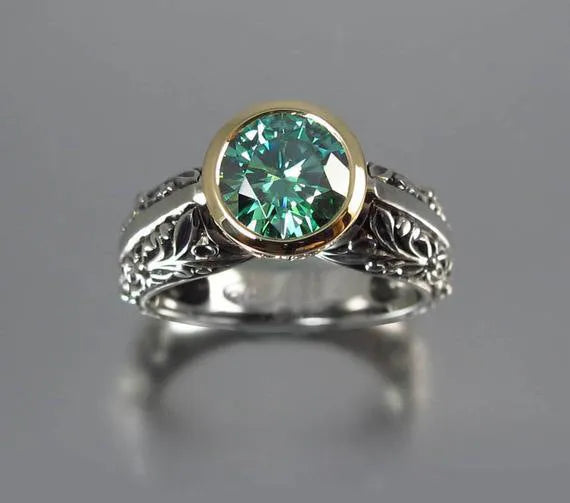 Gold-plated women's ring with flower design featuring green gemstone accents and colour separation details