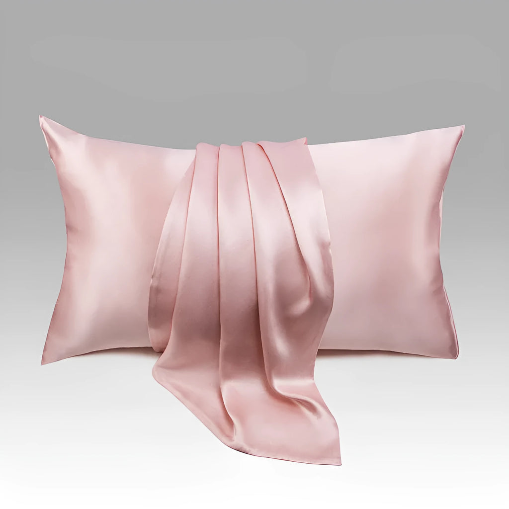 Dark grey 19 M mulberry silk pillowcase with envelope closure on a bed.