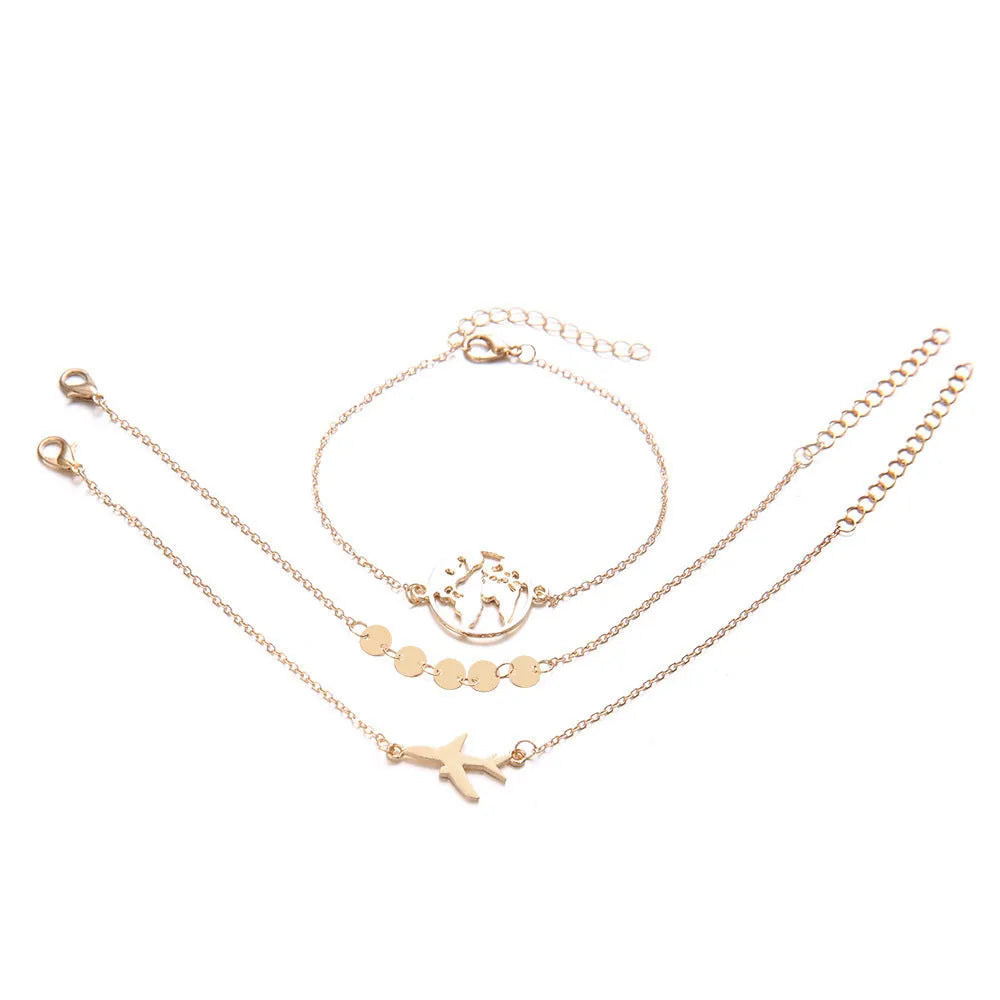 Three bohemian-style alloy bracelets with heart-shaped aircraft map charms on a white background.