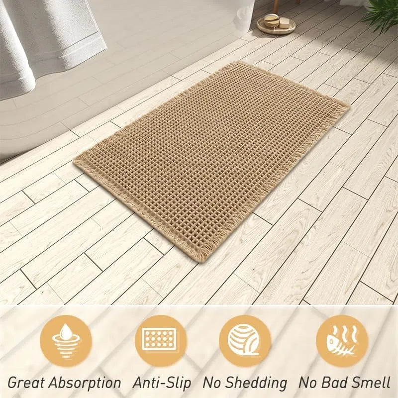 Modern checkered pattern absorbent non-slip bathroom floor mat in a neutral colour on tiled floor.