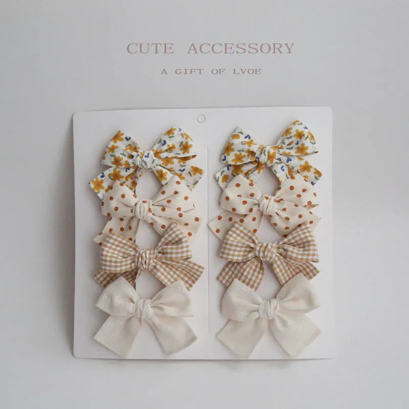 Children's fabric dovetail bow hair clips in eight pattern options