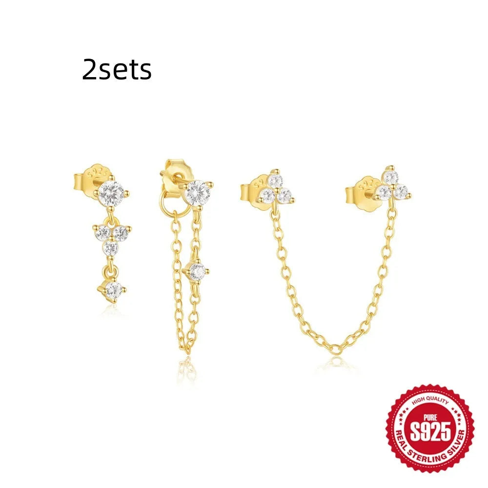 Set of three S925 sterling silver geometric tassel ear studs with zircon details on a plain background.