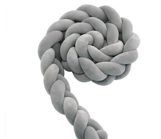 Bendable braid-knot baby crib bumper in spandex velvet, shown in a light grey colour wrapped around a cot.