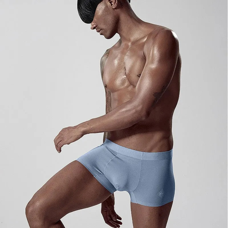 Seamless modal men's underwear in green, pink, and white colours with mid-waist design