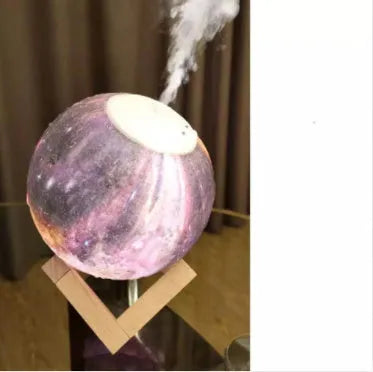 Lunar sphere humidifier and night light in wood finish with white LED light on a bedside table