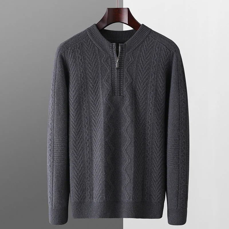 Man wearing a milky white half-zip wool sweater with a diamond pattern, showing loose fit and long sleeves.