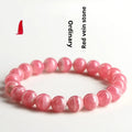 Women's geometric crystal bracelet with a red rhodochrosite stone and silver longevity lock clasp.
