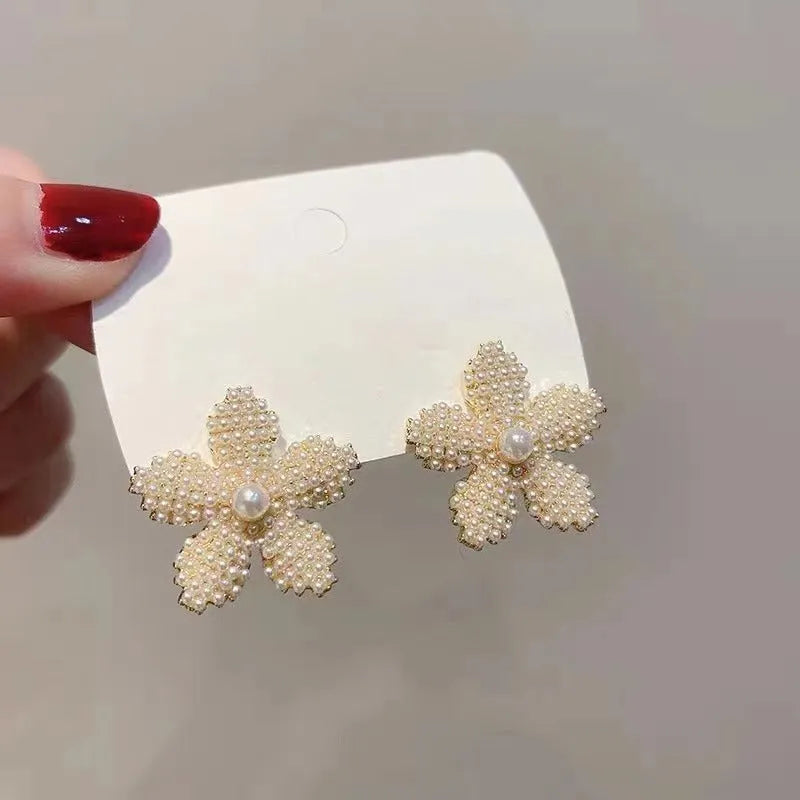 Korean style gold pineapple starfish pearl earrings made from electroplated alloy with inlaid stones.