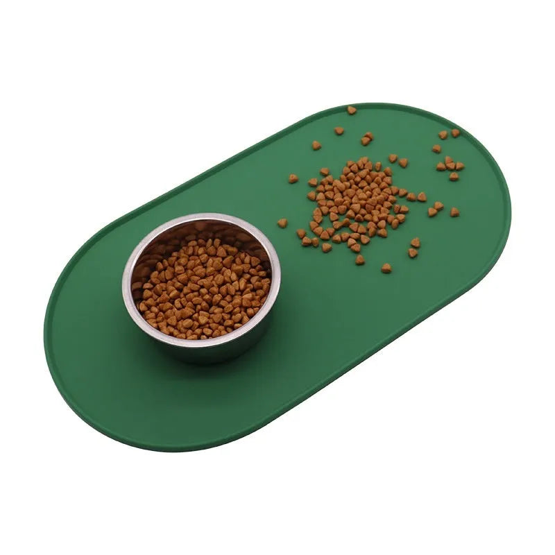 Silicone waterproof cat feeding placemat in beige colour on a wooden floor next to a pet bowl.