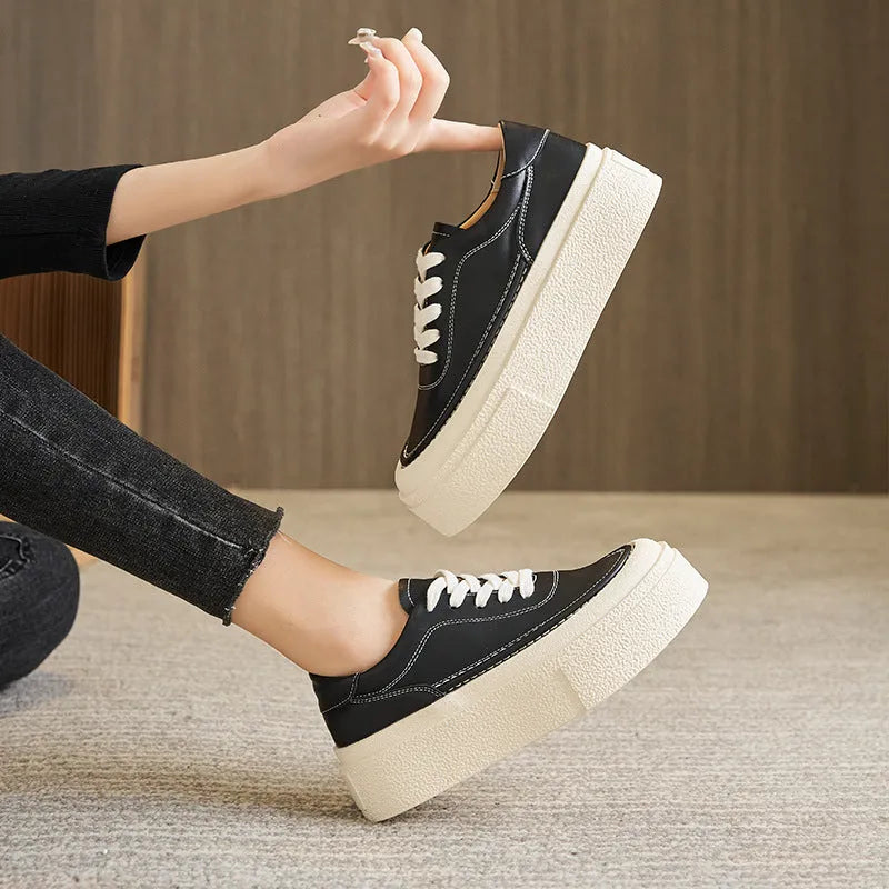 Women's black platform casual board shoes with embossed cowhide upper and round toe design