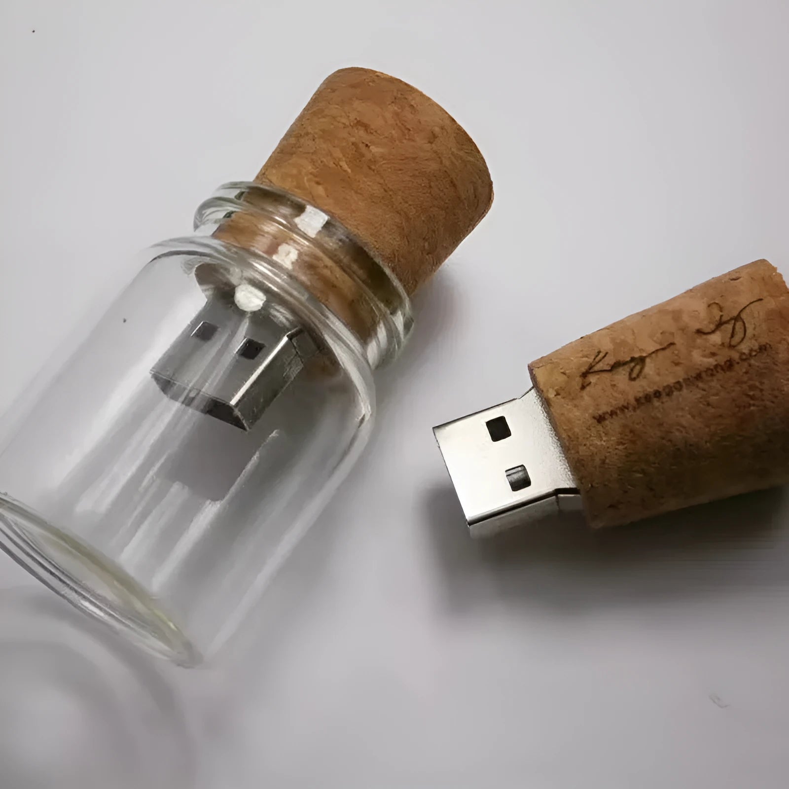 Transparent glass bottle USB flash drive with a wooden stopper cap, 60mm long.