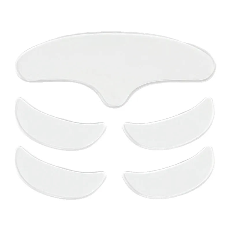 Five transparent silicone anti-wrinkle face stickers laid flat