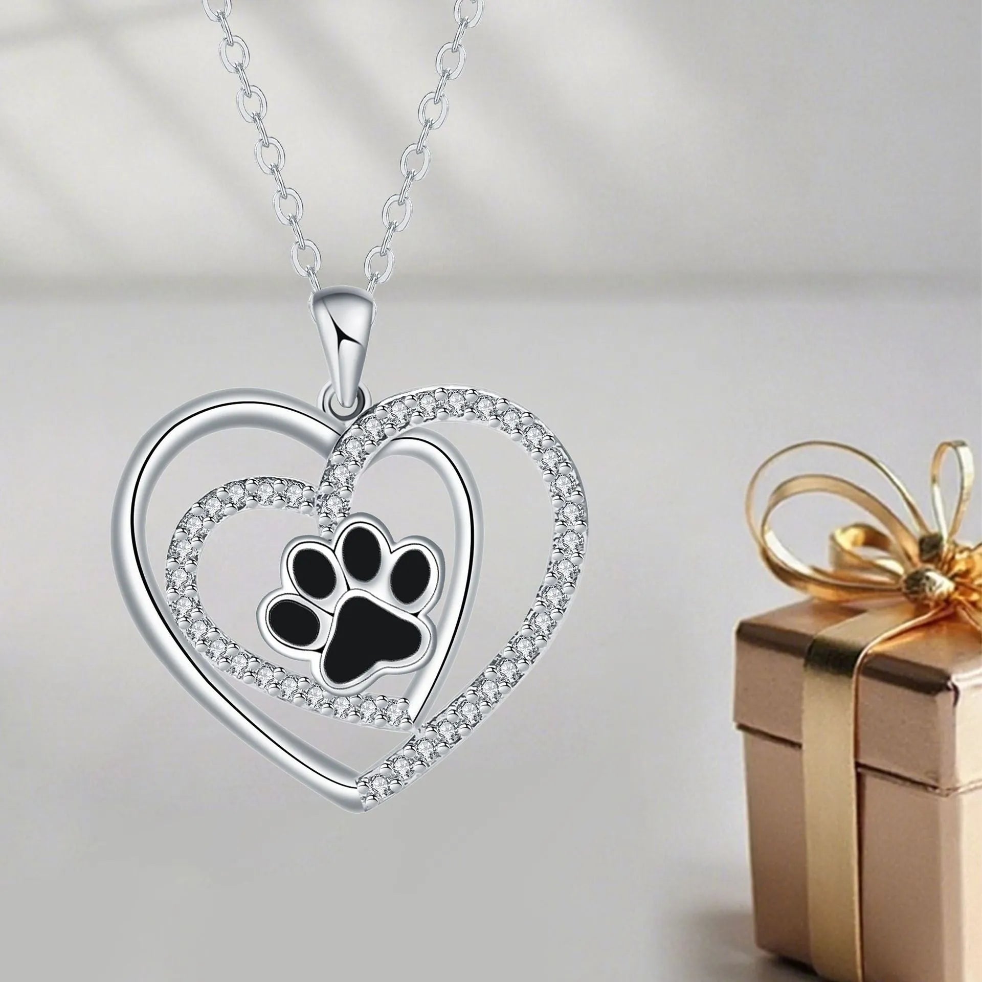 Women's copper necklace with heart-shaped dog paw print pendant on a cross chain